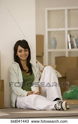 Woman drinking coffee in new house View Large Photo Image Stock Image - Woman drinking coffee in new house. Fotosearch
