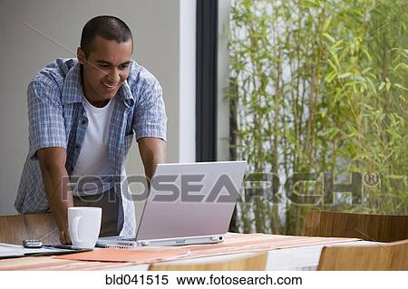 Young businessman working from home View Large Photo Image Stock Photography - Young businessman working from home. Fotosearch
