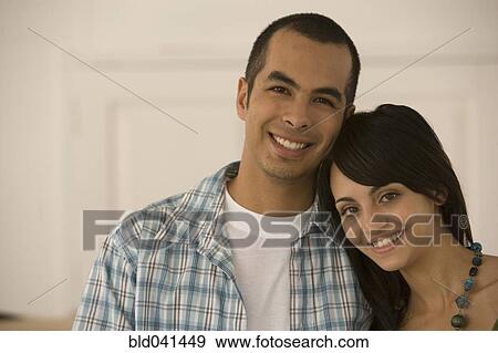 Stock Photo - Young couple hugging. Fotosearch
