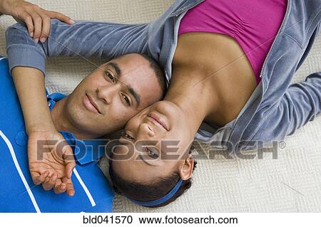 Young couple laying with heads touching View Large Photo Image Stock Image - Young couple laying with heads touching. Fotosearch