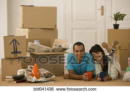 Young couple next to unpacked moving boxes View Large Photo Image Stock Photograph - Young couple next to unpacked moving boxes. Fotosearch