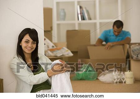 Young couple unpacking boxes in new house View Large Photo Image Stock Photography - Young couple unpacking boxes in new house. Fotosearch