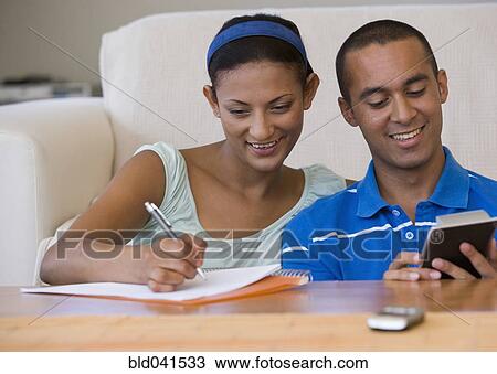 Young couple using calculator View Large Photo Image Stock Image - Young couple using calculator. Fotosearch