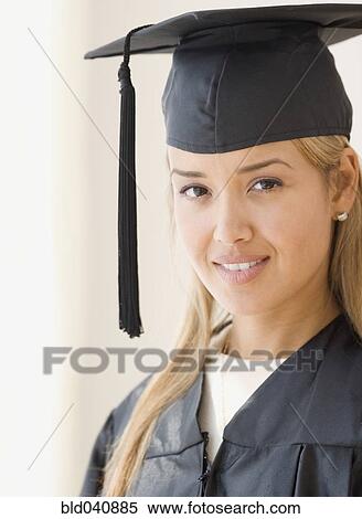Young Hispanic woman wearing graduation cap and gown View Large Photo Image Stock Photography - Young Hispanic woman wearing graduation cap and gown. Fotosearch