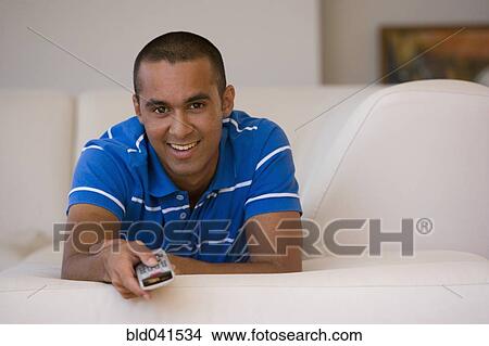 Young man pointing remote control View Large Photo Image Picture - Young man pointing remote control. Fotosearch