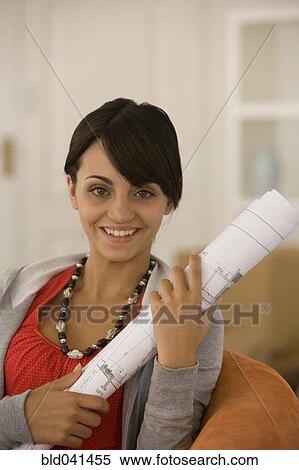 Young woman holding blueprints View Large Photo Image Stock Photography - Young woman holding blueprints. Fotosearch