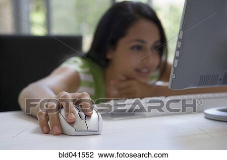 Young woman looking at looking at computer View Large Photo Image Stock Image - Young woman looking at looking at computer. Fotosearch