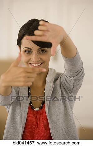 Young woman making frame with fingers View Large Photo Image Stock Photo - Young woman making frame with fingers. Fotosearch