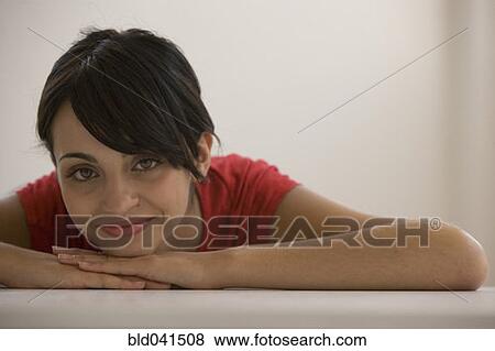 Young woman resting chin on hands View Large Photo Image Stock Photo - Young woman resting chin on hands. Fotosearch