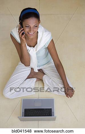Young woman talking on cell phone View Large Photo Image Stock Photo - Young woman talking on cell phone. Fotosearch