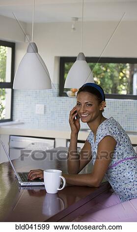 Young woman talking on cell phone View Large Photo Image Stock Photo - Young woman talking on cell phone. Fotosearch
