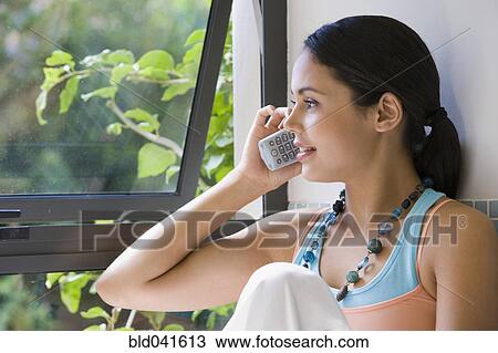 Young woman talking on telephone View Large Photo Image Stock Image - Young woman talking on telephone. Fotosearch