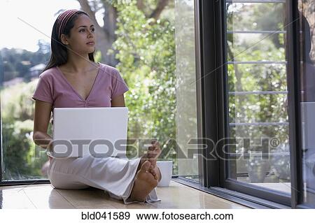 Young woman typing on laptop View Large Photo Image Stock Photo - Young woman typing on laptop. Fotosearch