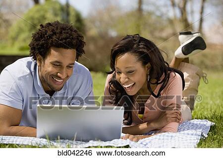 African American couple looking at laptop View Large Photo Image Stock Photograph - African American couple looking at laptop. Fotosearch