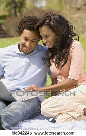 African American couple looking at laptop View Large Photo Image Stock Photography - African American couple looking at laptop. Fotosearch