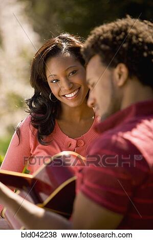 African American man playing guitar for girlfriend View Large Photo Image Stock Photo - African American man playing guitar for girlfriend. Fotosearch