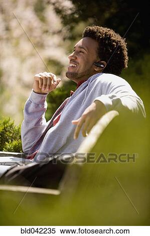 Stock Photography - African American man talking on cell phone. Fotosearch