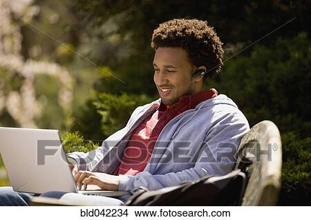 African American man typing on laptop View Large Photo Image Picture - African American man typing on laptop. Fotosearch