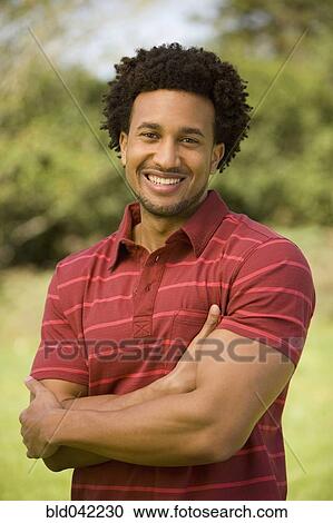Stock Image - African American man with arms crossed. Fotosearch