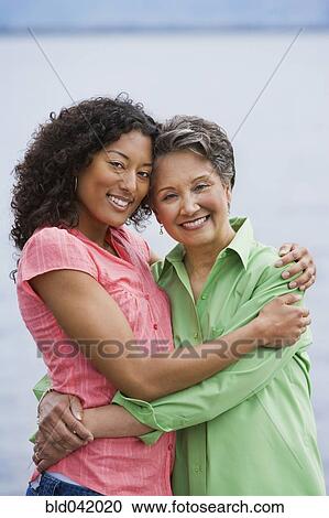 African American mother and adult daughter hugging View Large Photo Image Stock Image - African American mother and adult daughter hugging. Fotosearch