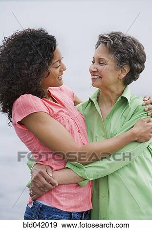 African American mother and adult daughter hugging View Large Photo Image Stock Photo - African American mother and adult daughter hugging. Fotosearch