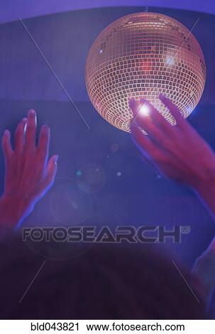 Stock Image - African American woman dancing at nightclub. Fotosearch
