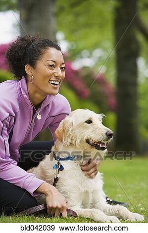 African American woman hugging dog View Large Photo Image Stock Photo - African American woman hugging dog. Fotosearch