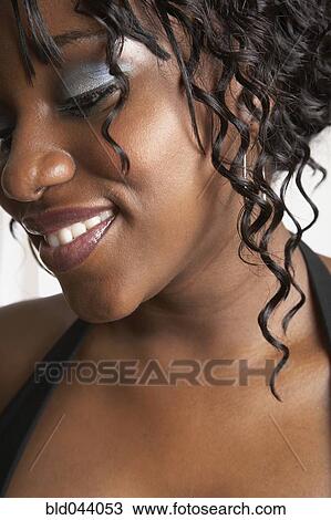 Stock Image - African American woman looking down. Fotosearch