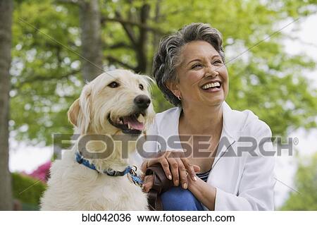 Stock Photograph - African American woman with dog. Fotosearch