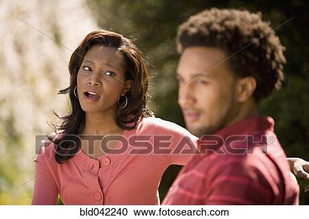 Stock Image - African American woman yelling at boyfriend. Fotosearch