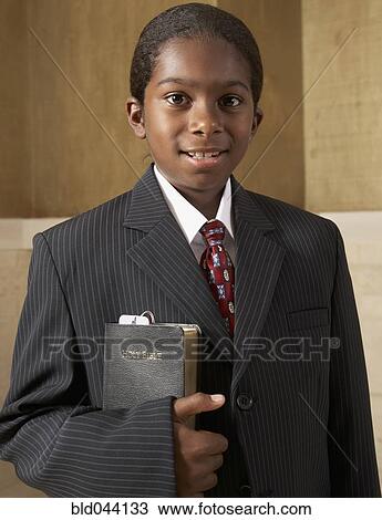 African boy in suit holding Bible View Large Photo Image Stock Image - African boy in suit holding Bible. Fotosearch
