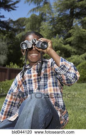 African boy looking through binoculars View Large Photo Image Stock Image - African boy looking through binoculars. Fotosearch