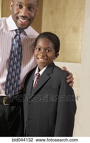 Stock Image - African father and son dressed in suits. Fotosearch