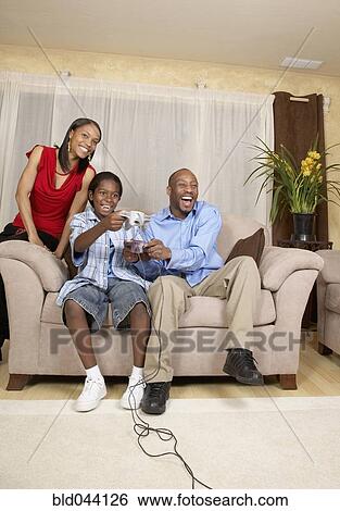 African father and son playing video games View Large Photo Image Stock Photograph - African father and son playing video games. Fotosearch
