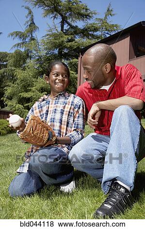 African father and son with baseball glove View Large Photo Image Stock Photo - African father and son with baseball glove. Fotosearch