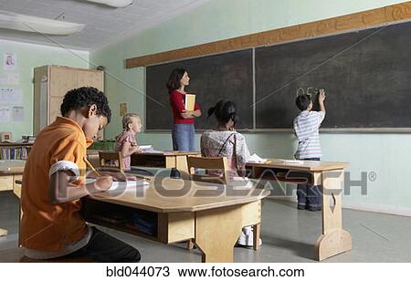 Asian boy writing on blackboard View Large Photo Image Stock Image - Asian boy writing on blackboard. Fotosearch