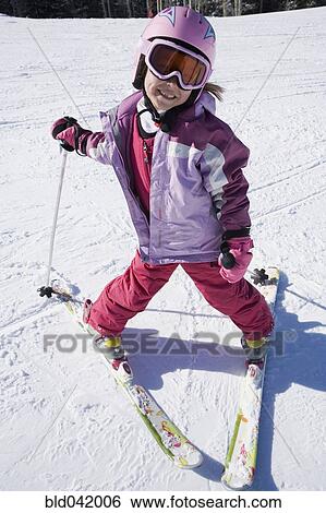Stock Photograph - Asian girl on skis. Fotosearch