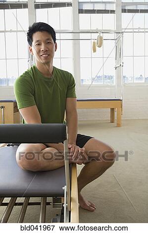 Asian man sitting in exercise studio View Large Photo Image Stock Photo - Asian man sitting in exercise studio. Fotosearch
