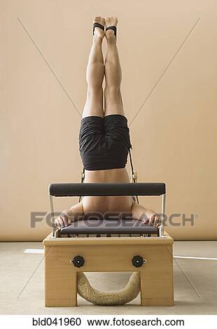 Asian man stretching on exercise equipment View Large Photo Image Stock Image - Asian man stretching on exercise equipment. Fotosearch