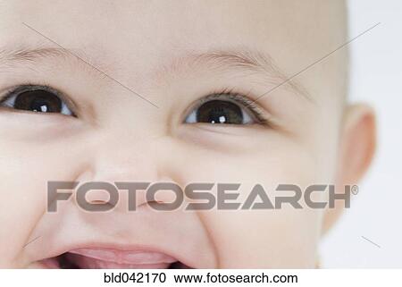 Stock Image - Close up of Hispanic baby smiling. Fotosearch