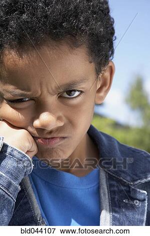 Close up of Mixed Race boy frowning View Large Photo Image Stock Photo - Close up of Mixed Race boy frowning. Fotosearch