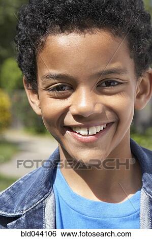 Stock Photograph - Close up of Mixed Race boy smiling. Fotosearch