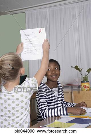 Female student holding A plus paper View Large Photo Image Stock Image - Female student holding A plus paper. Fotosearch