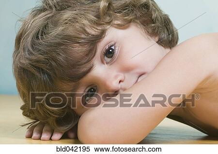 Hispanic boy laying on floor View Large Photo Image Stock Photography - Hispanic boy laying on floor. Fotosearch