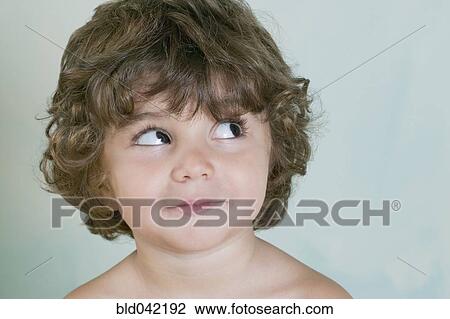 Stock Image - Hispanic boy looking sideways. Fotosearch