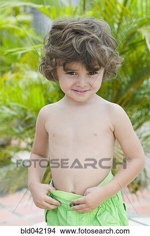 Picture - Hispanic boy wearing bathing suit. Fotosearch
