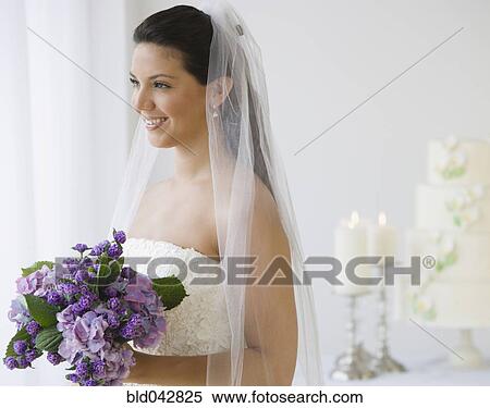 Hispanic bride holding bouquet of flowers View Large Photo Image Stock Photography - Hispanic bride holding bouquet of flowers. Fotosearch