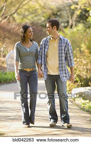 Stock Image - Hispanic couple holding hands. Fotosearch