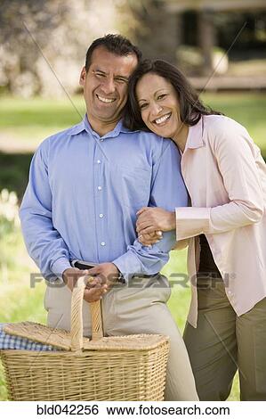 Hispanic couple holding picnic basket View Large Photo Image Stock Photograph - Hispanic couple holding picnic basket. Fotosearch