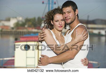 Stock Image - Hispanic couple hugging. Fotosearch